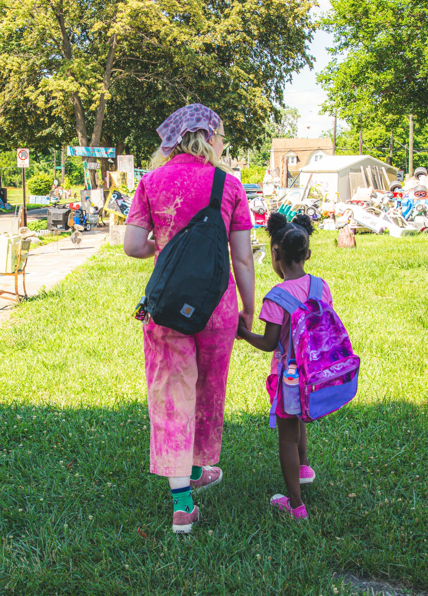 Woman walking with child at Heidelberg Project